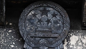 A charred national emblem of the People's Republic of China is seen in San Francisco